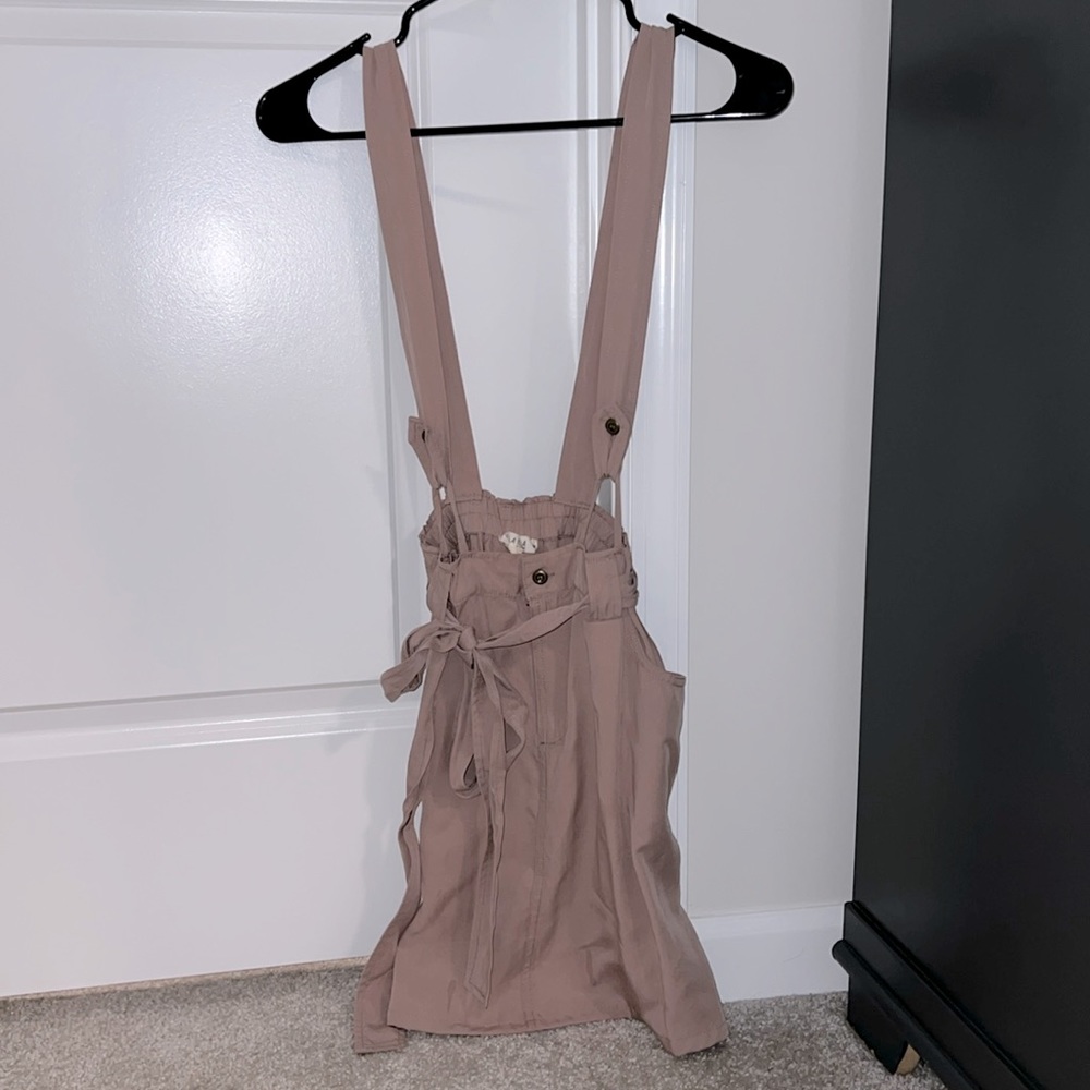 Super cute overall skirt with pockets and tie feature
